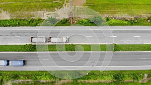 Drone shot high angle Aerial view of highway traffic at the countryside, The car truck and motorcycle transport