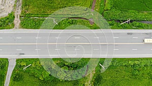 Drone shot high angle aerial view of highway traffic at the countryside, the car truck and motorcycle transport