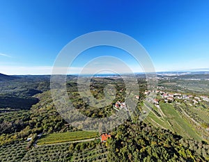 Drone shot of houses in Capodistria city on the green Luka Koper harbor in Slovenia