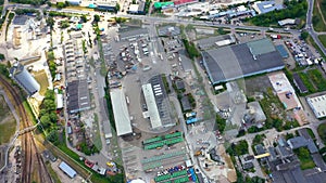 Drone shot of industrial zone with thick smog and burning fossil fuels. Zoom in aerial shot of factory zone shot from top, air