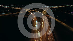 Drone shot on a large freeway tie with bridges and viaducts at night.