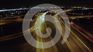 Drone shot on a large freeway tie with bridges and viaducts at night.