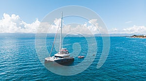 Drone shot of luxury catamaran yacht and small speedboat in the sea of Caribbean