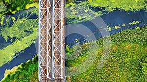 Drone shot of a metal bridge over a river