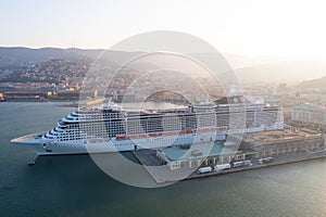 Drone shot of the nautical and a cruise ship MSC Fantasia anchored in seaport Trieste, Italy