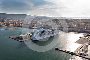 Drone shot of the nautical and a cruise ship MSC Fantasia anchored in seaport Trieste, Italy