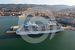 Drone shot of the nautical and a cruise ship MSC Fantasia anchored in seaport Trieste, Italy