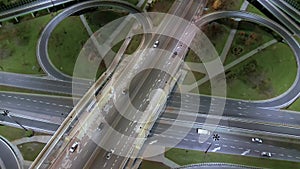 Drone shot of night traffic on a motorway showing cars and lanes of light with bridges and viaducts outside the city of Warsaw,