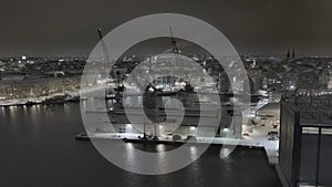 Drone shot of the Punavuori area in Helsinki during the winter. Harbour cranes.