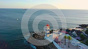 Drone shot of Santa Marta lighthouse and seascape, Cascais, Portugal at sunset