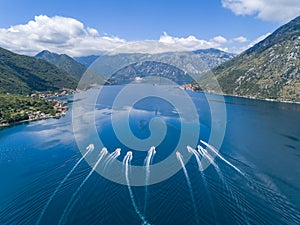 Drone shot of speedboats cruising the Boka Bay, Montenegro. photo