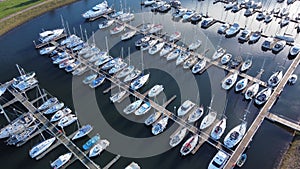 Drone shot of ships and boats near the wooden docks at harbor