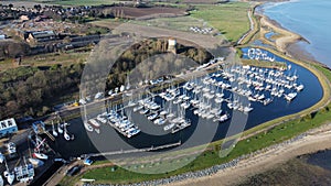 Drone shot of ships and boats near the wooden docks at harbor