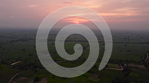 Drone shot of sunrise above the crop fields