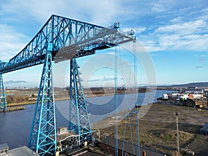 Drone shot of tees transporter bridge over the sea in a port under blue cloudy sky