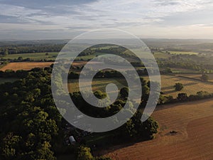 Drone shot of trees and agricultural fields in Boarhunt, Hampshire, UK