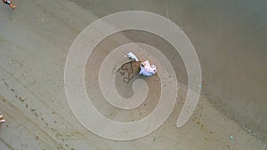 Drone shot of two newlyweds standing in front of a heart with their initials drawn