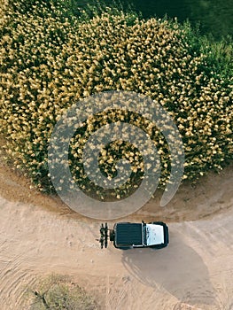 Drone shot of the white jeep on a dirt desert road