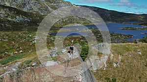 Drone shot of woman in nordic sweater hike on hill