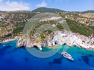 Drone shot of Zakynthos island with beautiful turquoise Ionian sea and limestone cliffs and cave near famous Navagio beach during