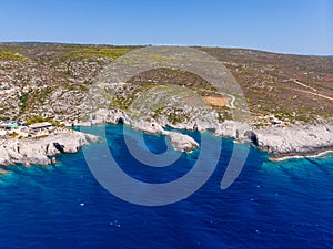 Drone shot of Zakynthos island with beautiful turquoise Ionian sea and limestone cliffs and cave at Porto Limnionas beach during