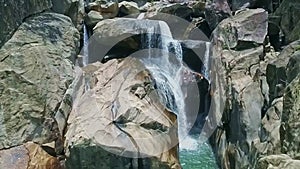Drone Shows Fantastic Waterfall Flowing on Rocks into Lake