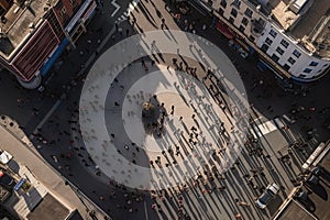 The drone soars high above the crowd, capturing a bird's eye view of the throng of people gathered below. Ai