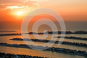 Drone sot of the sunset scene over the Palm Jumeirah Island in Dubai, United Arab Emirates