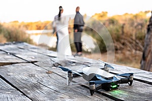 Drone standing on the table with wedding couple in nature