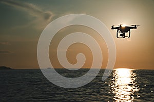 The drone in the sunset sky. ocean wave mountains Close up of quadrocopter outdoors. concept for film maker wedding videography