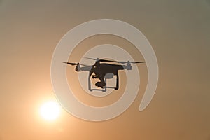 The drone in the sunset sky. ocean wave mountains Close up of quadrocopter outdoors. concept for film maker wedding videography