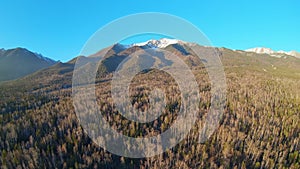 Drone takes off over the forest at the foot of the Sayan mountain range