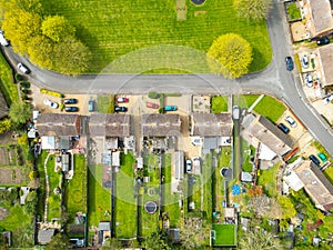 Drone top down view of typical English semi-detached houses showing there extended gardens.