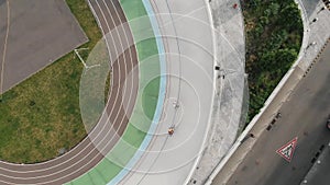 Drone top view of cycling track in Kiev. Training at velodrome. Cycling training. Male cyclists are riding on fixed gear bikes