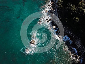 Drone top view of a sea cliff and a beach