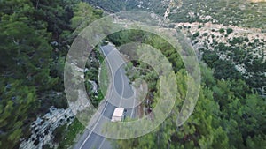 Drone tracks car on mountain road, perfect for trip, car enthusiasts. Captures essence of trip, car journey through