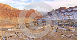 DRONE: Two cargo lorries meet while driving through the wintry canyon in Utah.