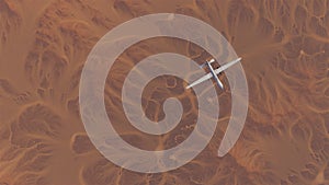 Drone Unmanned Aerial Vehicle Aircraft High Altitude Above Arid Mountain Desert with Sediment Mudflat