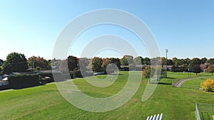 Drone video flying over a soccer field of the Riviere-Nord public park in St-Eustache at the beginning of Autumn