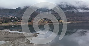 Drone video of a Lake In Romania, Europe. Breathtaking view in a foggy morning