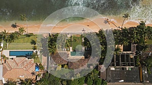 Drone video of retro villa on tropical island near ocean with sandy beach. Top view of antique luxury house with pool