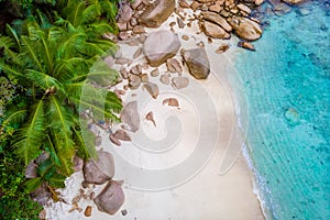 Drone view from above at Anse Lazio beach Praslin Island Seychelles, couple men and woman on beach