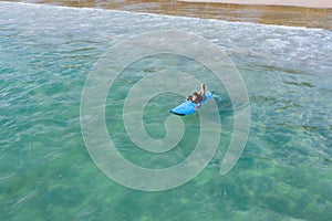 Drone view of Asian Surf board man plays surf in the sea beach at Kata Beach, Phuket Thailand