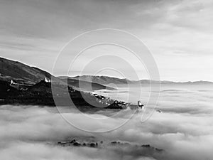 Drone view of Assisi Umbria Italy above a sea of fog