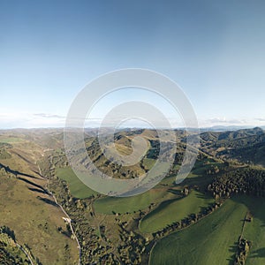 Drone view of autumn meadow hiils and forest