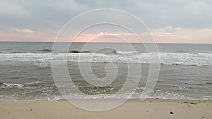 Drone view of beautiful seamless never ending footage while turquiose sea waves breaking on sandy coastline. Aerial shot of golden