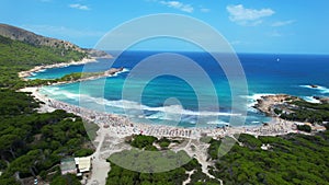 Drone view of Cala Agulla beach in Mallorca, Spain, on a hot summer day