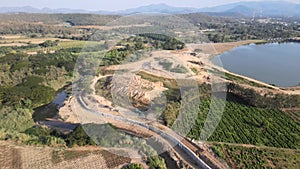 Drone view of a channel flows between agricultural fields in the daytime