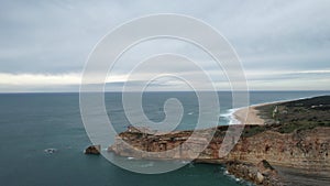 Drone view of cliff and lighthouse in Nazare, Portugal