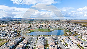 A drone view of a community in Oakley, California with a lake in the center photo